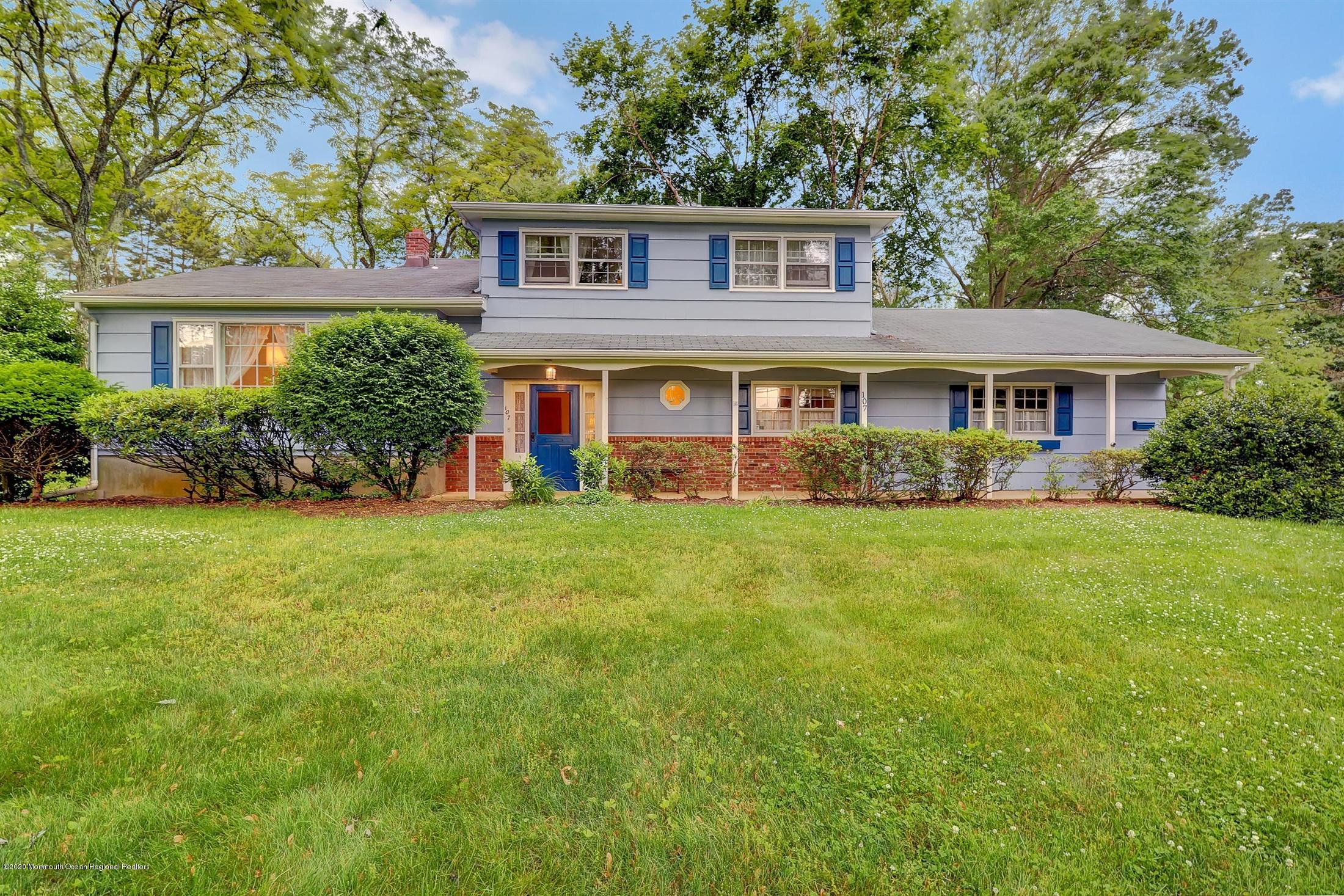 107 Jumping Brook Road Lincroft, NJ 07738 - Photo 1 of 30 front view of a house next to a yard