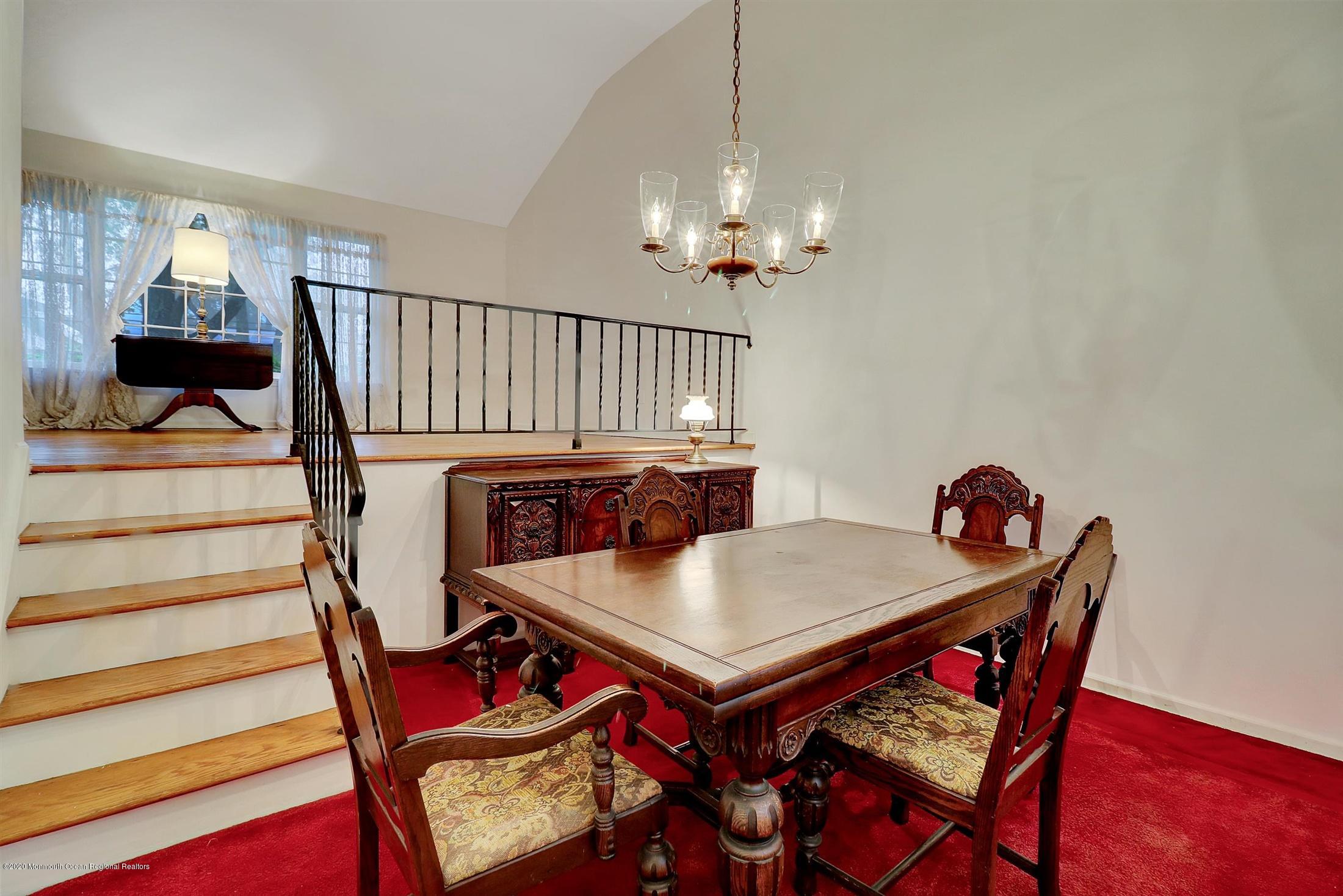 107 Jumping Brook Road Lincroft, NJ 07738 - Photo 11 of 30 a view of a dining room with furniture and wooden floor