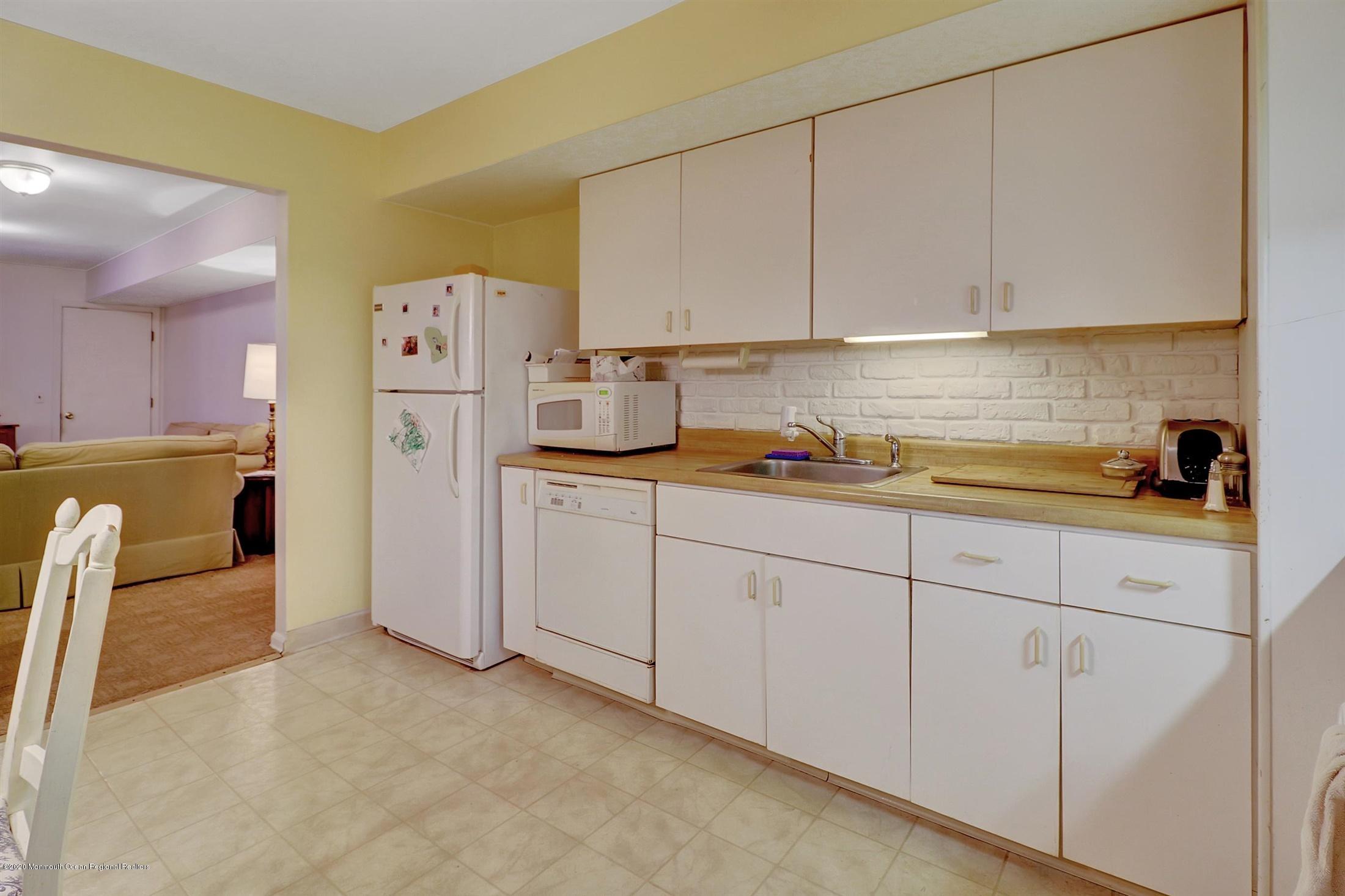 107 Jumping Brook Road Lincroft, NJ 07738 - Photo 13 of 30 a kitchen with cabinets and appliances