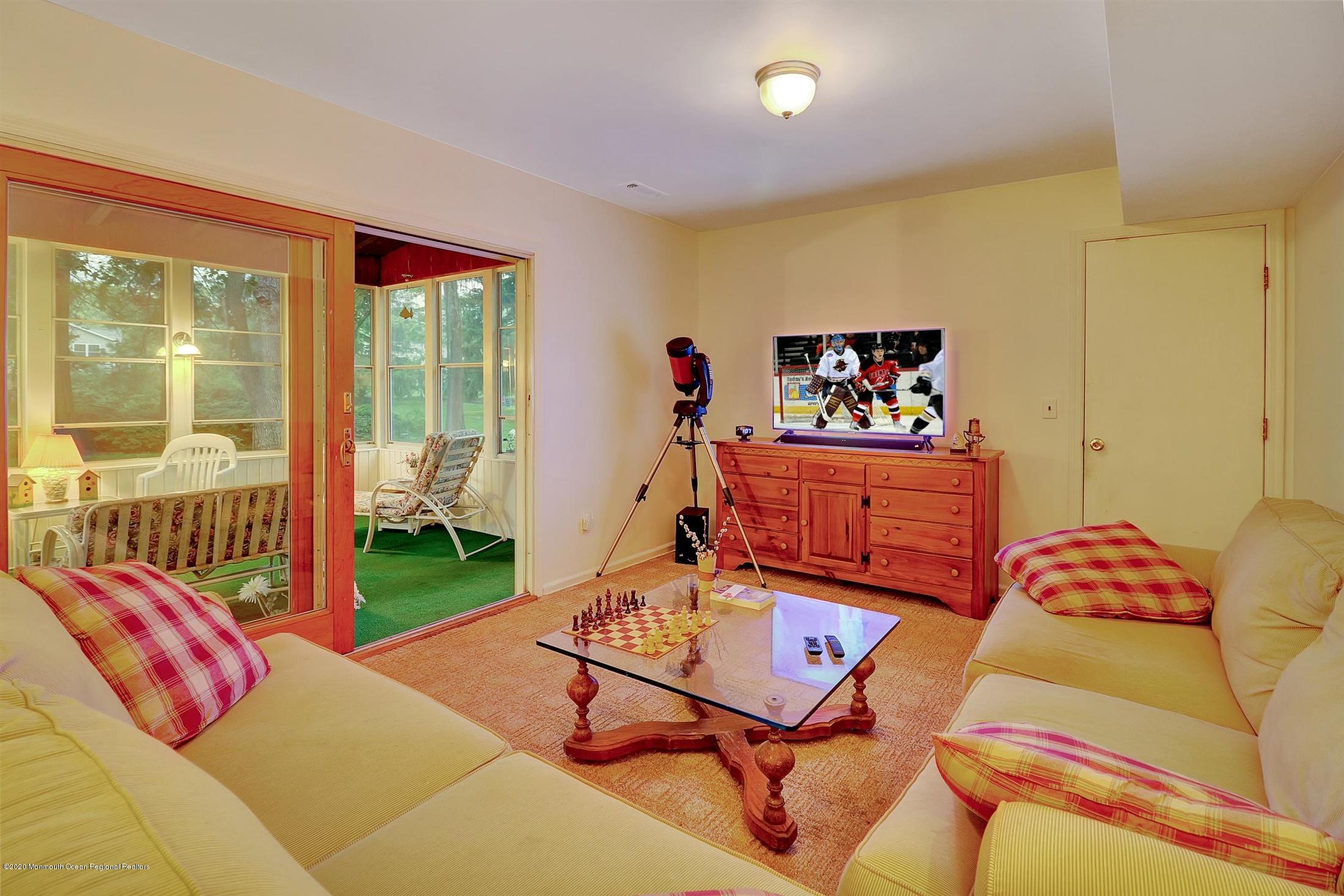 107 Jumping Brook Road Lincroft, NJ 07738 - Photo 16 of 30 a living room with furniture a rug and a large window