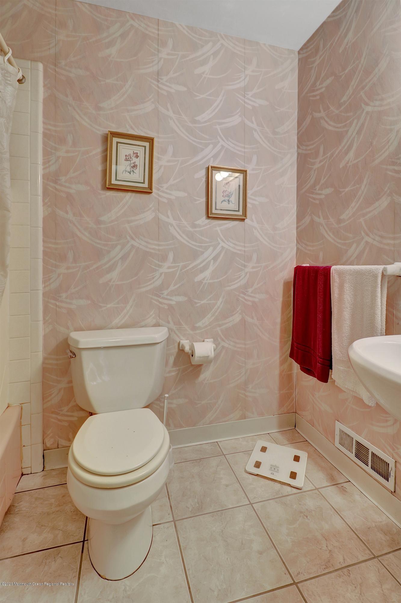 107 Jumping Brook Road Lincroft, NJ 07738 - Photo 24 of 30 a white toilet sitting next to a bathroom sink