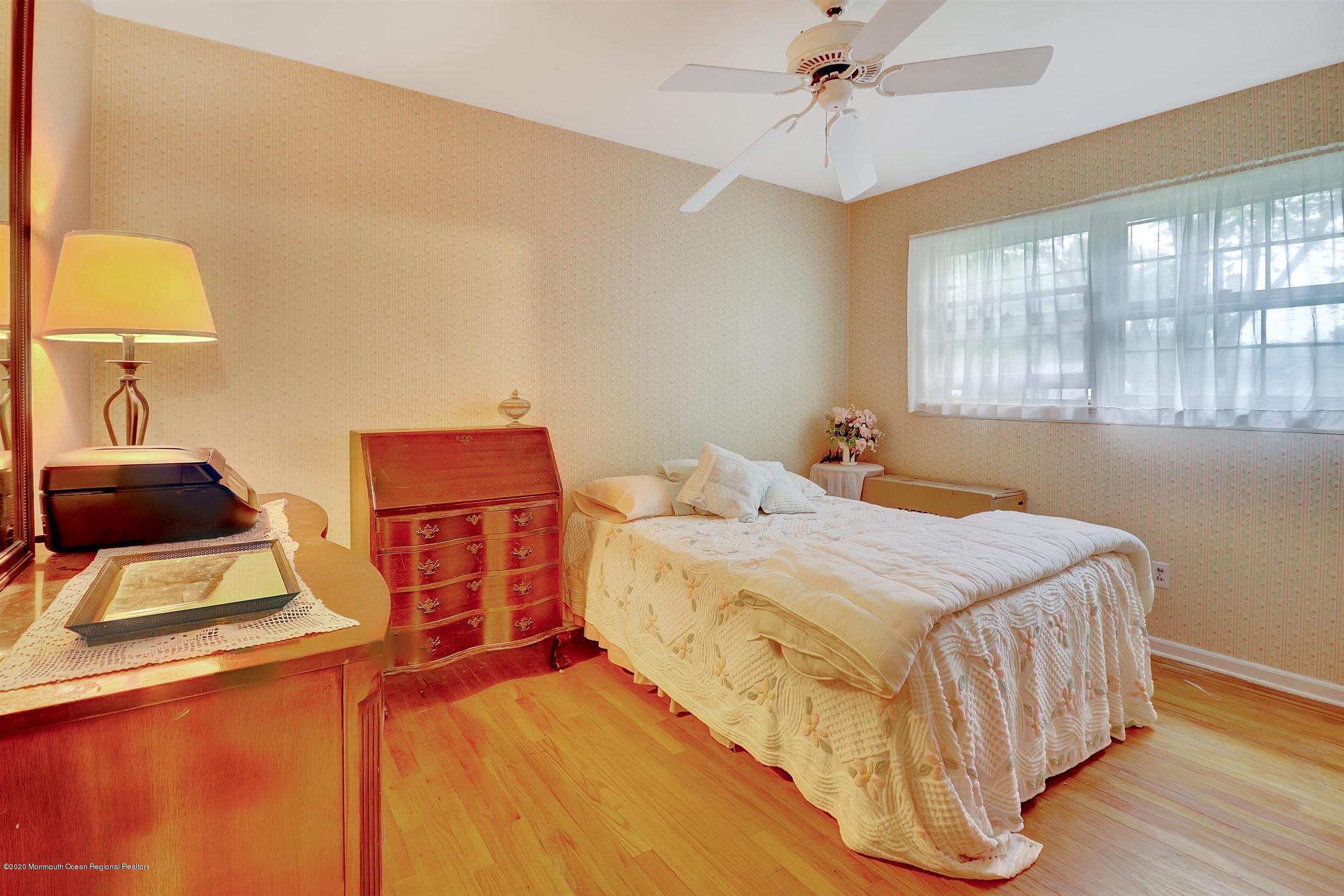 107 Jumping Brook Road Lincroft, NJ 07738 - Photo 25 of 30 a bedroom with a bed and wooden floor