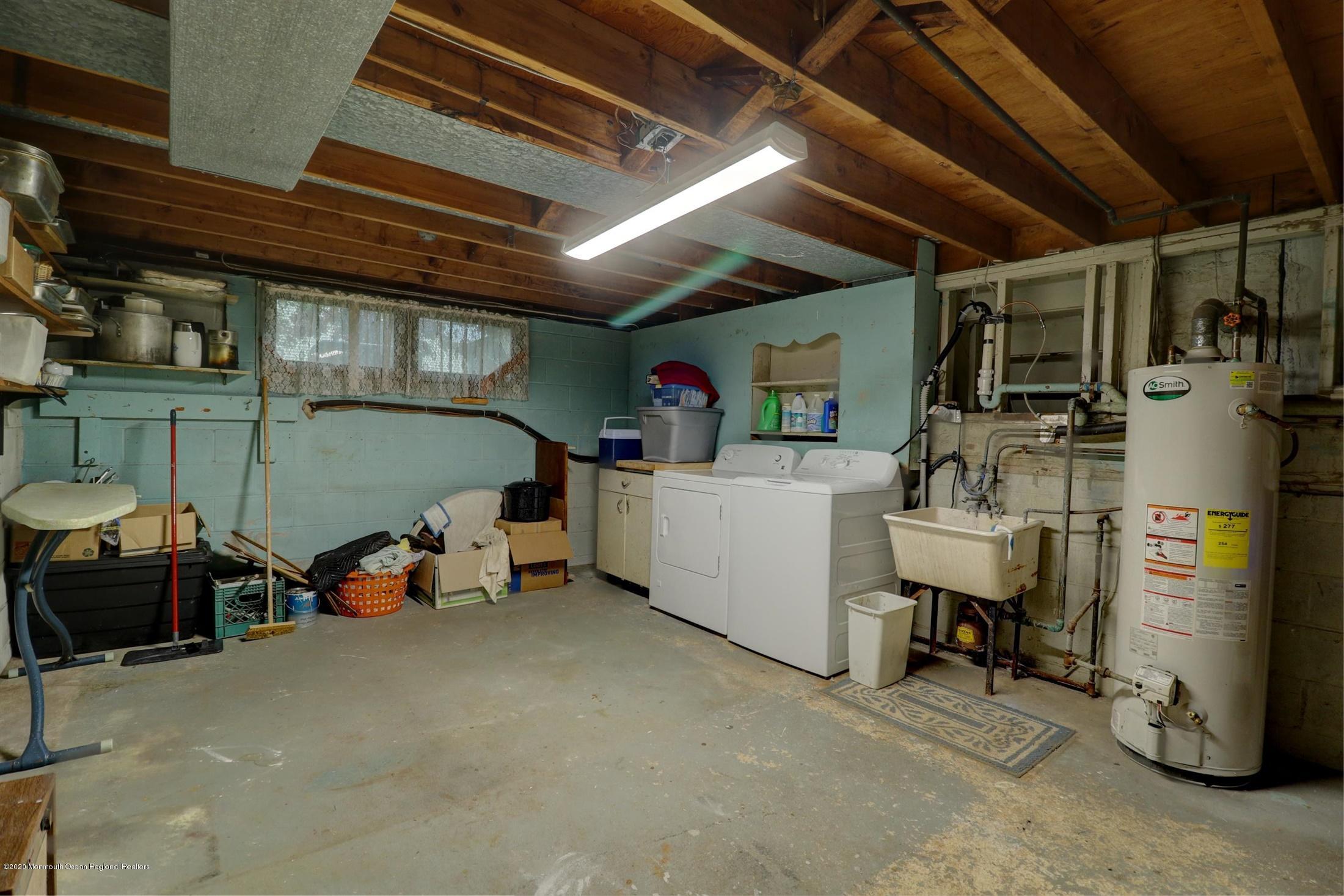 107 Jumping Brook Road Lincroft, NJ 07738 - Photo 30 of 30 a view of a garage with table and chairs