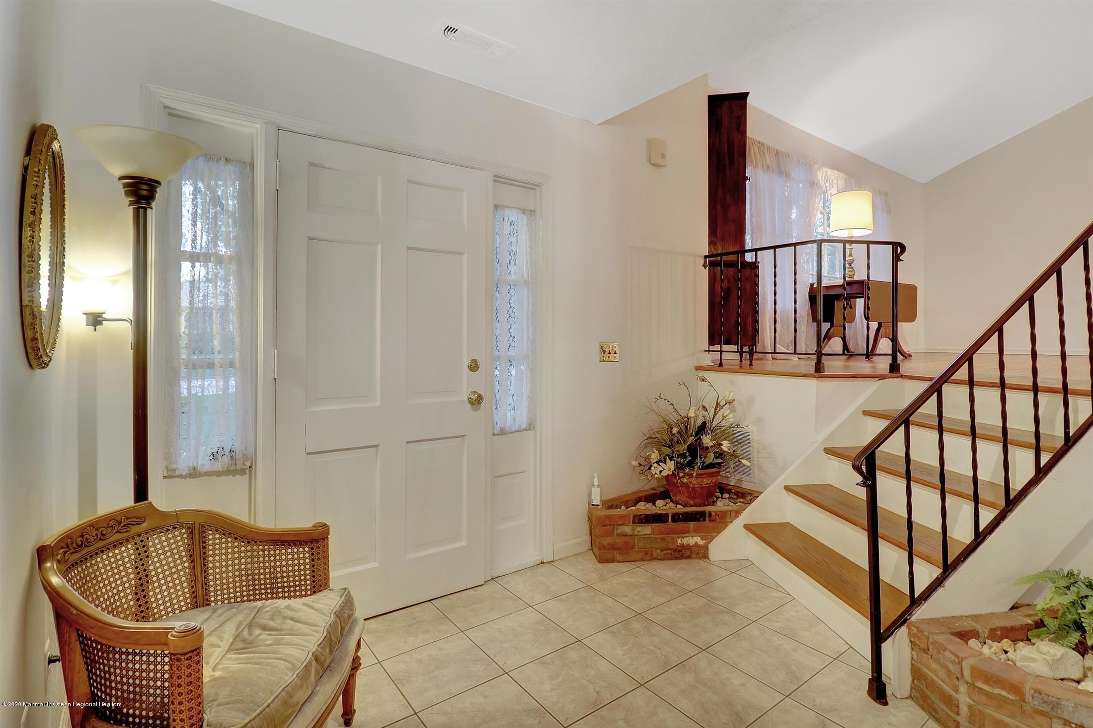 107 Jumping Brook Road Lincroft, NJ 07738 - Photo 7 of 30 a living room with furniture and a potted plant