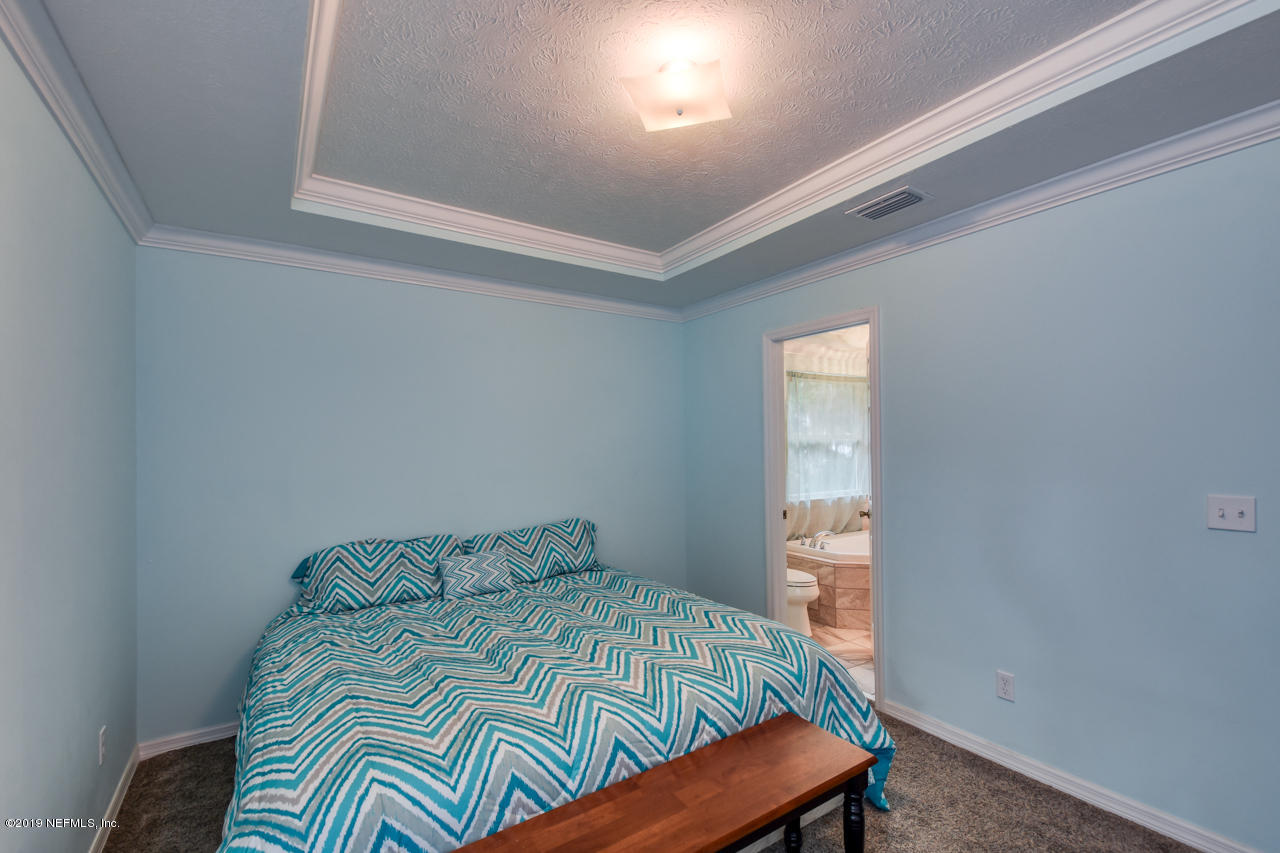 8224 River Road St. Augustine, FL 32092 - Photo 23 of 41 Master Bedroom with En Suite Bath