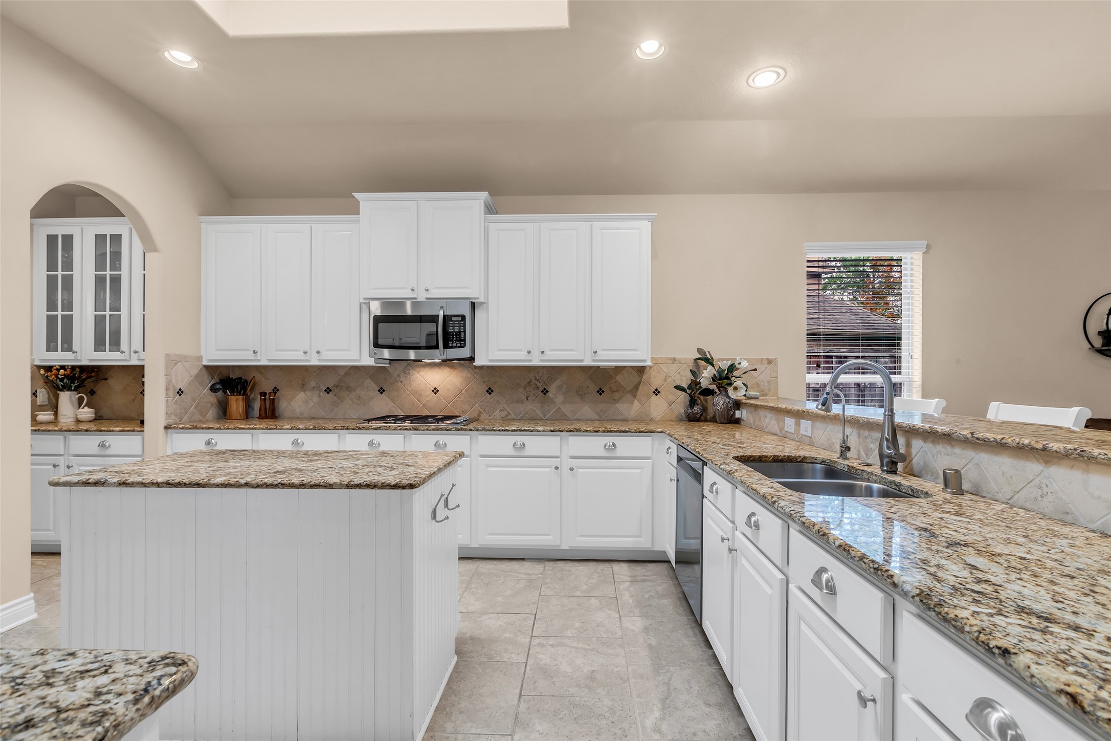 10 Pilot Rock Place Tomball, TX 77375 - Photo 6 of 23 a kitchen with granite countertop cabinets stainless steel appliances a sink and a counter top space