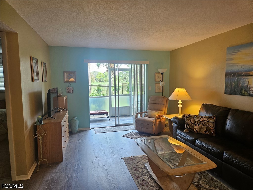6777 Winkler Road, Unit 168 Fort Myers, FL 33919 - Photo 7 of 15 a living room with furniture and a flat screen tv
