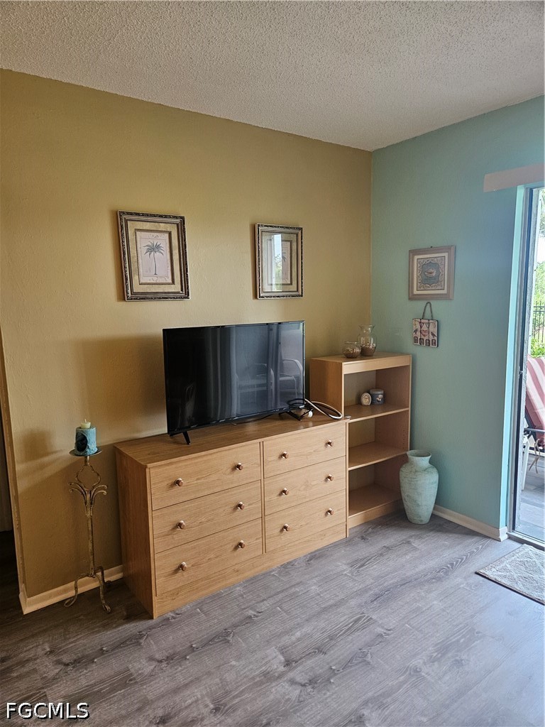 6777 Winkler Road, Unit 168 Fort Myers, FL 33919 - Photo 9 of 15 a bedroom with a bed and furniture