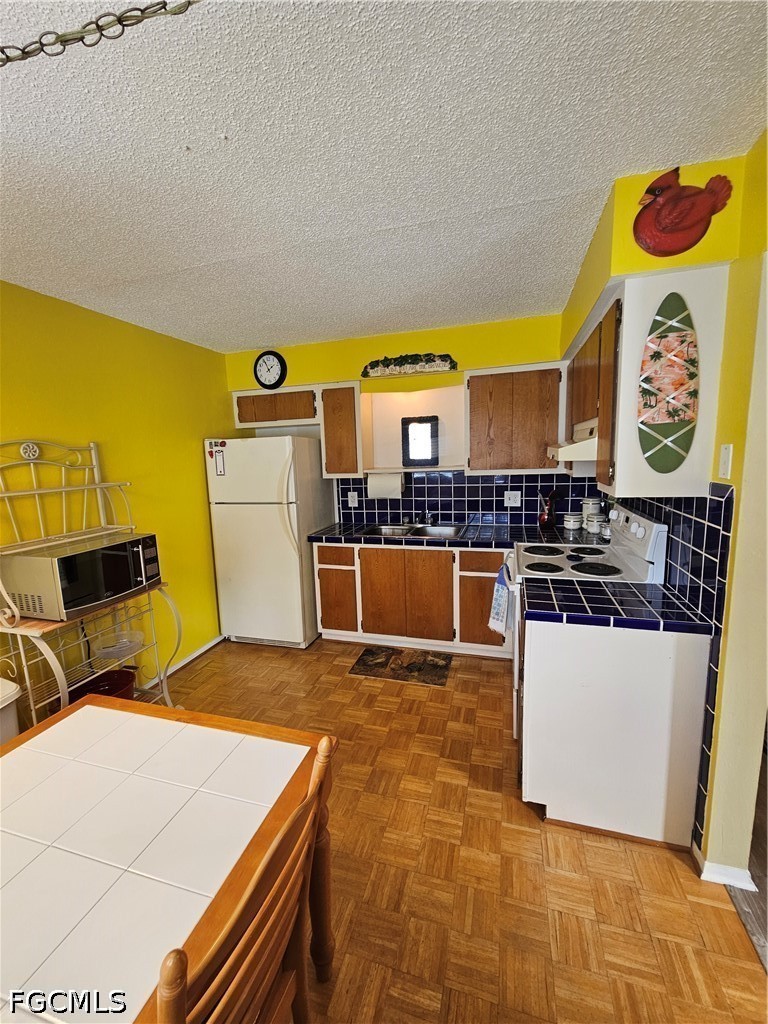 6777 Winkler Road, Unit 168 Fort Myers, FL 33919 - Photo 10 of 15 a kitchen with stainless steel appliances a stove a sink and a microwave