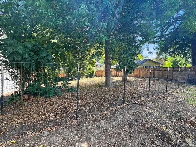 a backyard of a house with lots of green space