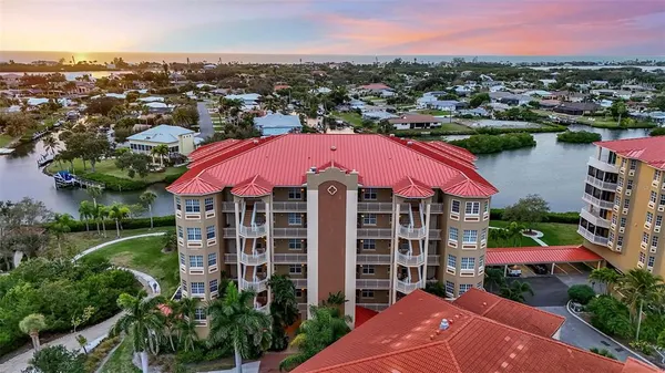 an aerial view of a house with a garden and lake view
