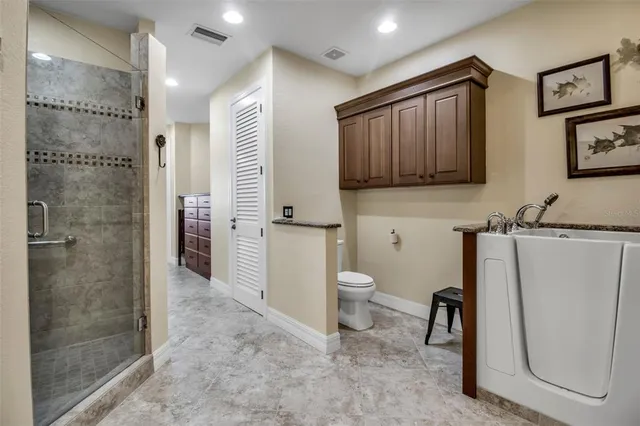 a bathroom with a toilet sink a shower and a mirror