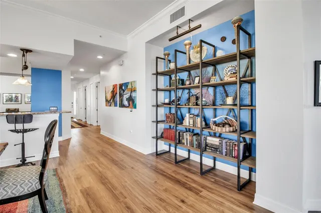 a living room with furniture a rug and a book shelf