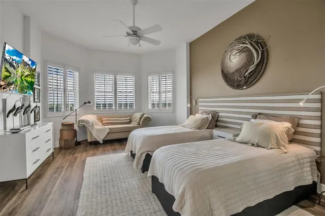 a bedroom with bed and a large window