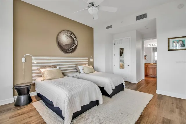 a bedroom with bed and a chandelier