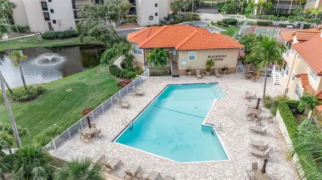 a view of a patio with a table and chairs under an umbrella