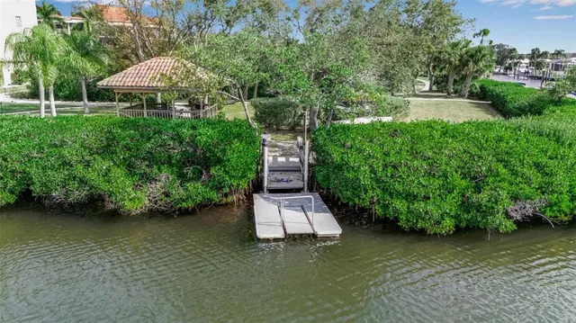 a swimming pool with outdoor seating and garden