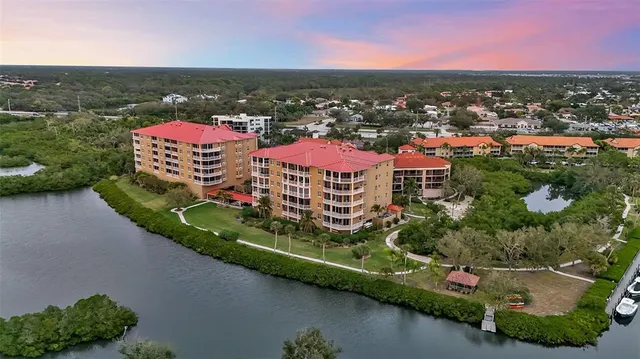 an aerial view of a house with a garden and lake view