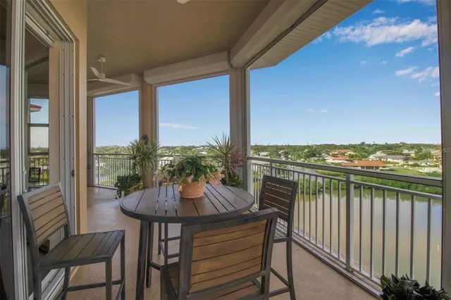 a view of a balcony with furniture and a floor to ceiling window