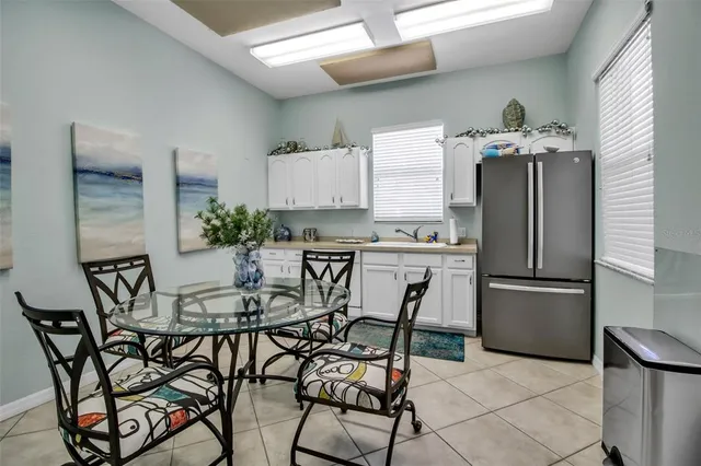 a kitchen with stainless steel appliances a refrigerator and a stove top oven
