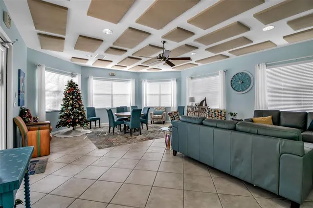 a living room with furniture a clock and a large window
