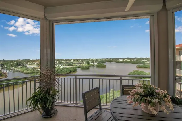 a view of a balcony with chairs and wooden floor