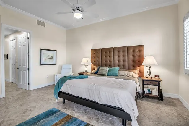 a bedroom with a bed a lamp and a dresser