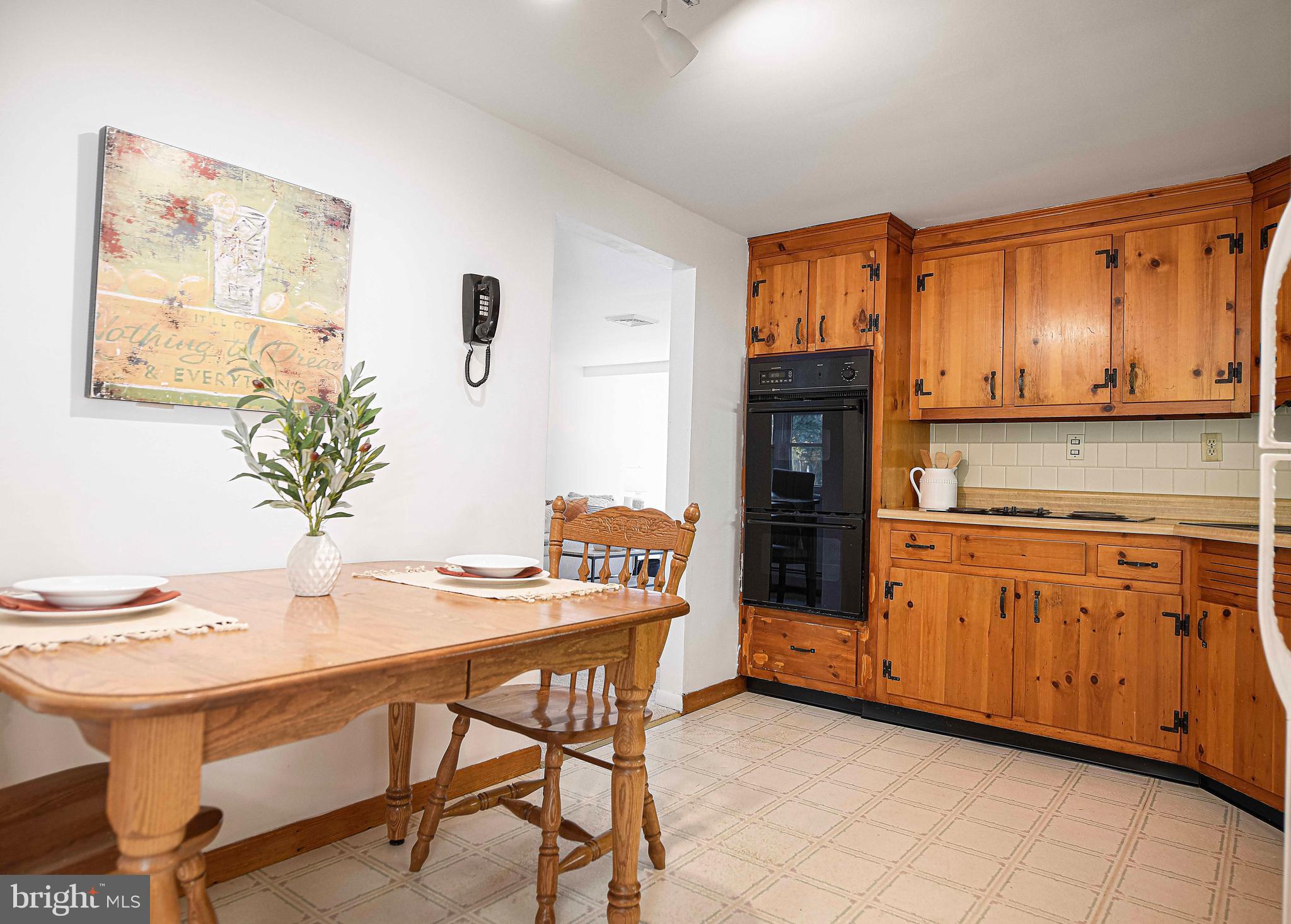 1710 Granite Road Darlington, MD 21034 - Photo 12 of 56 a kitchen with stainless steel appliances kitchen island granite countertop a table chairs in it and wooden floors