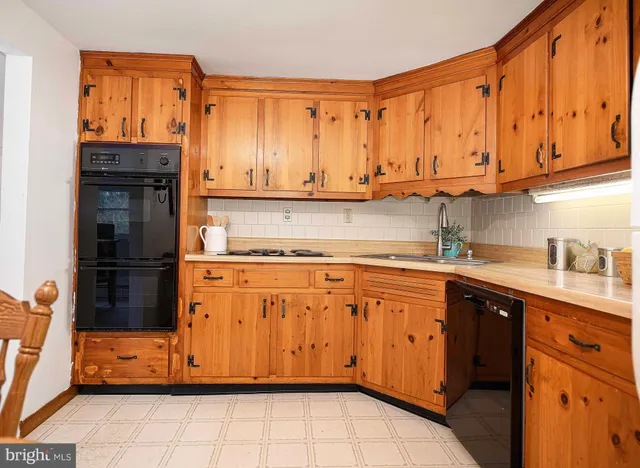 a kitchen with stainless steel appliances granite countertop a refrigerator sink and cabinets