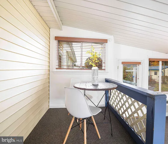 a living room with furniture and large windows
