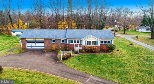 a view of an house with backyard space and balcony
