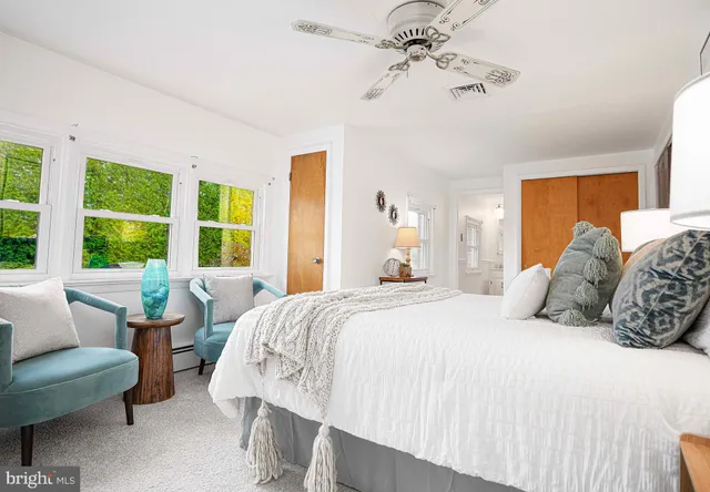 a bathroom with a sink toilet and window