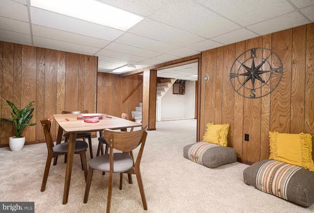a view of a dining room with furniture and a chandelier