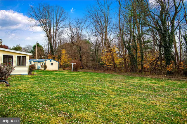 an aerial view of a house with garden space and street view
