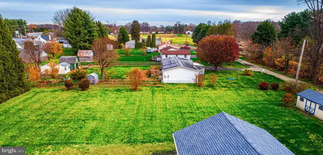 an aerial view of a house with yard