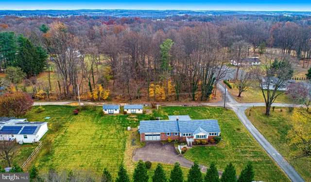an aerial view of residential houses with outdoor space and street view