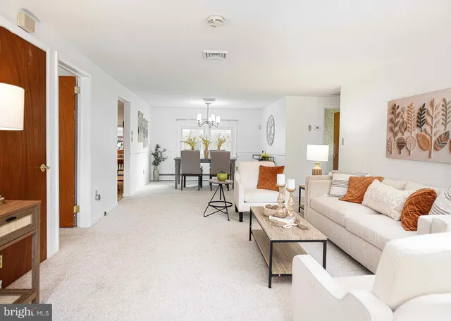 a view of a dining room with furniture and a chandelier