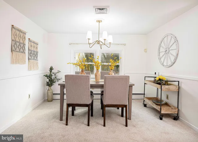 a view of a dining room with furniture and chandelier