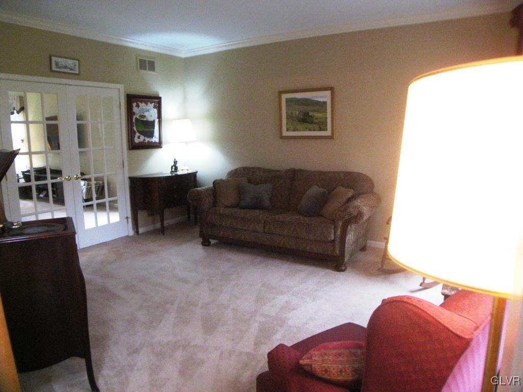 5912 Ricky Ridge Trail Orefield, PA 18069 - Photo 6 of 42 Living room with crown molding and french doors to