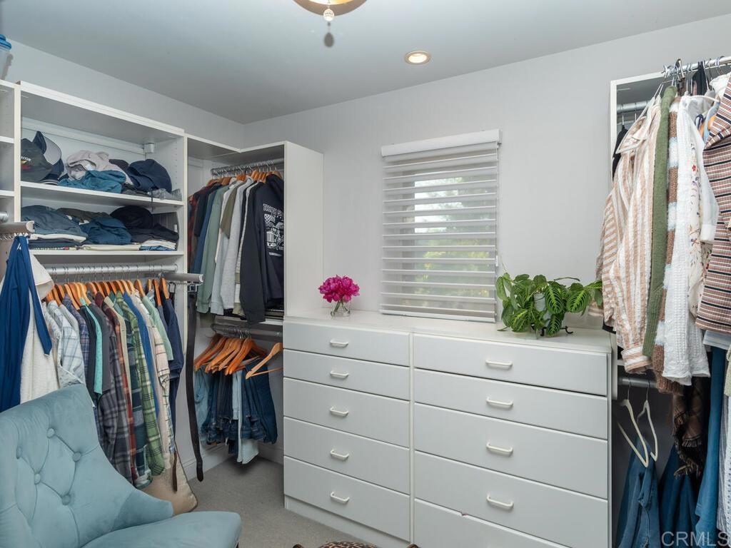 31267 Rancho Amigos Road Bonsall, CA 92003 - Photo 26 of 74 a view of walk in closet with clothes and shoes