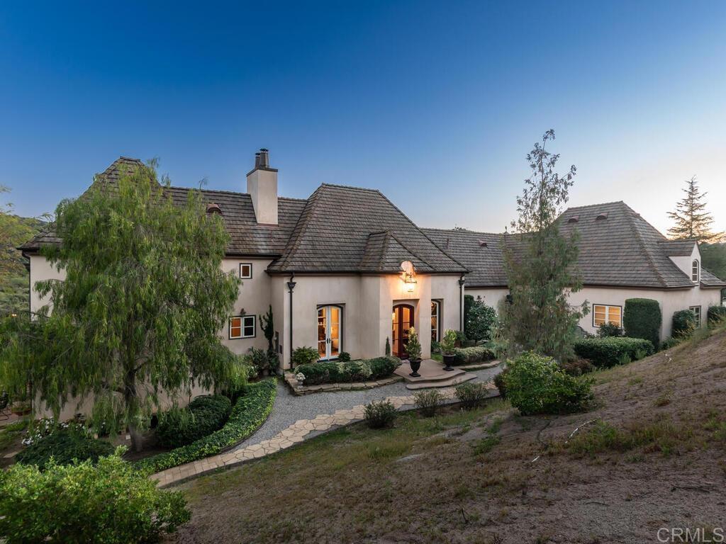 31267 Rancho Amigos Road Bonsall, CA 92003 - Photo 58 of 74 a front view of a house with garden