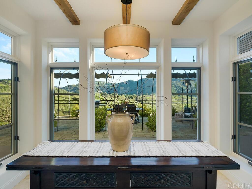 31267 Rancho Amigos Road Bonsall, CA 92003 - Photo 10 of 74 a view of a dining room with furniture wooden floor and chandelier