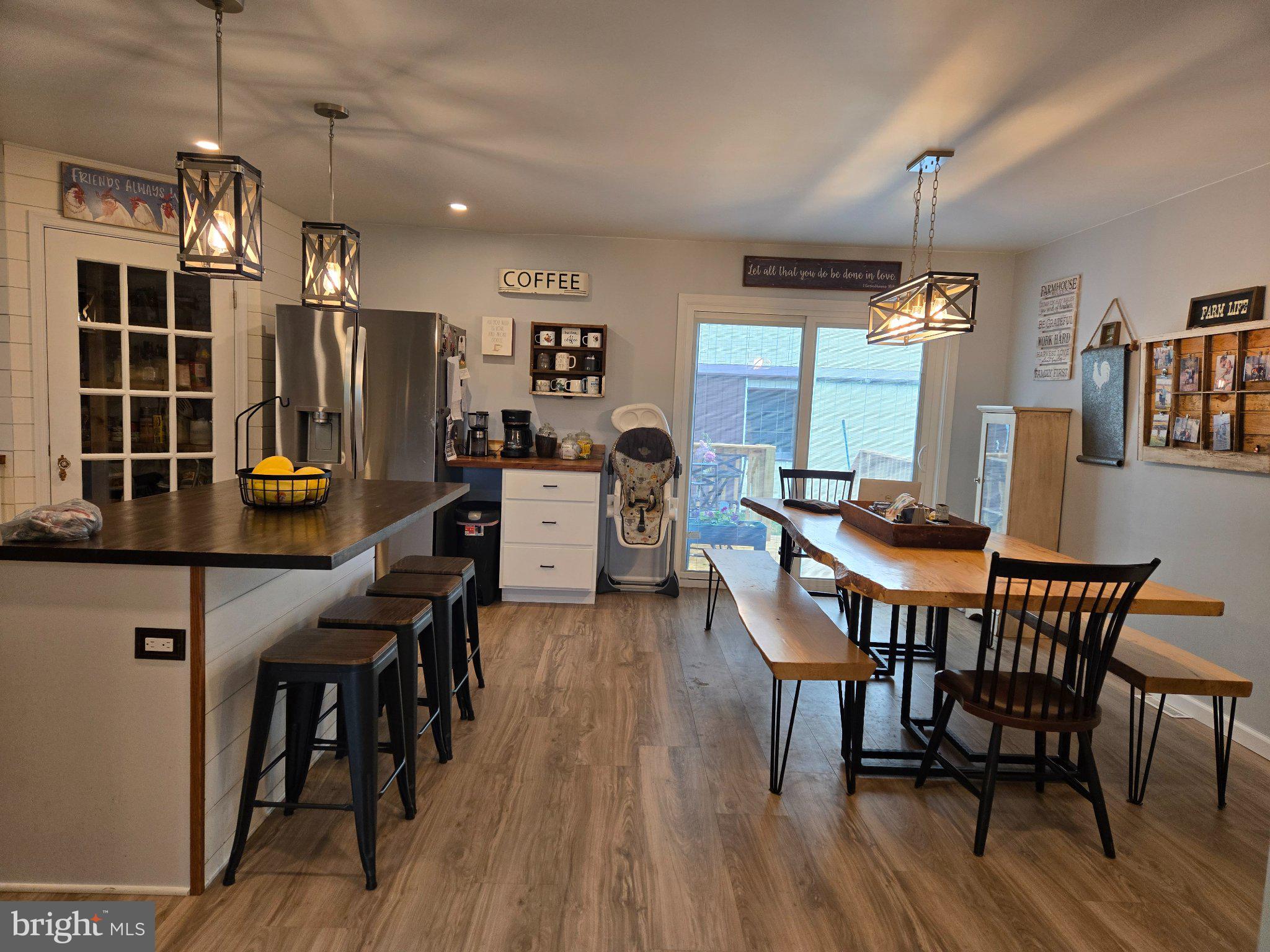 1669 Colebrook Road Lebanon, PA 17042 - Photo 23 of 34 a dining room with stainless steel appliances kitchen island granite countertop a table chairs and a refrigerator