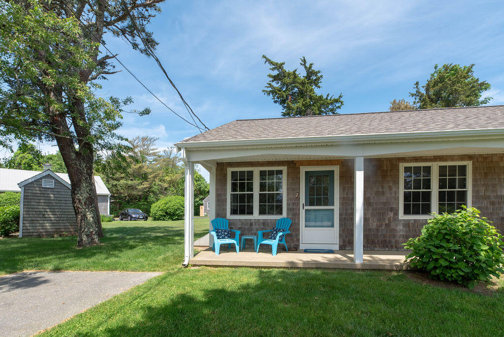 170 Beach Road, Unit 2A Orleans, MA 02653 - Photo 1 of 11 front view of a house with a yard