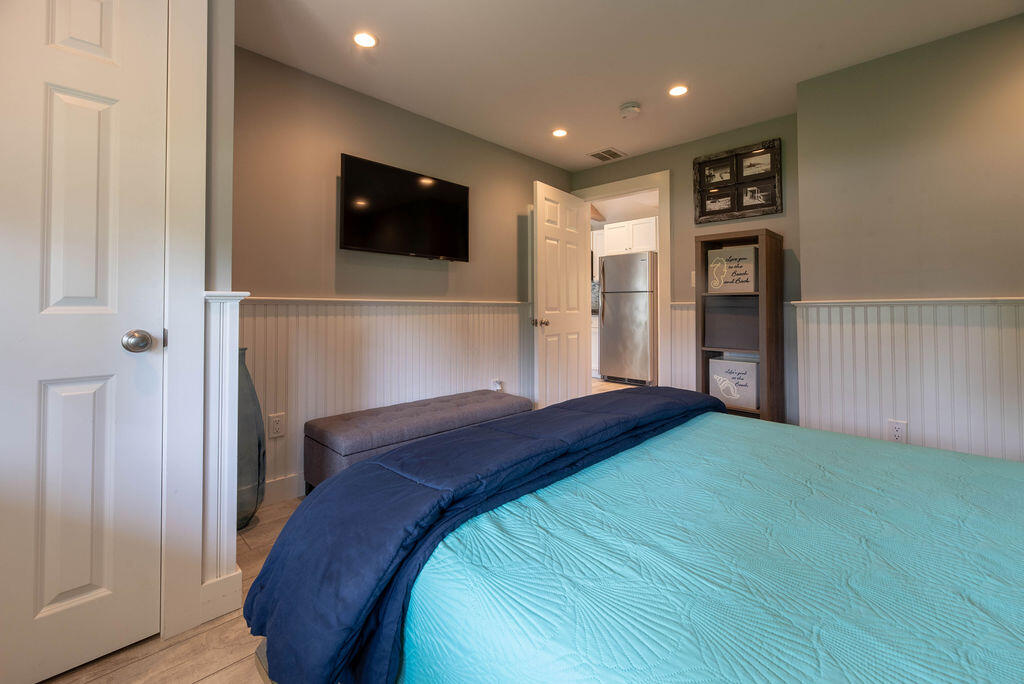 170 Beach Road, Unit 2A Orleans, MA 02653 - Photo 7 of 11 a bedroom with a bed and a flat screen tv