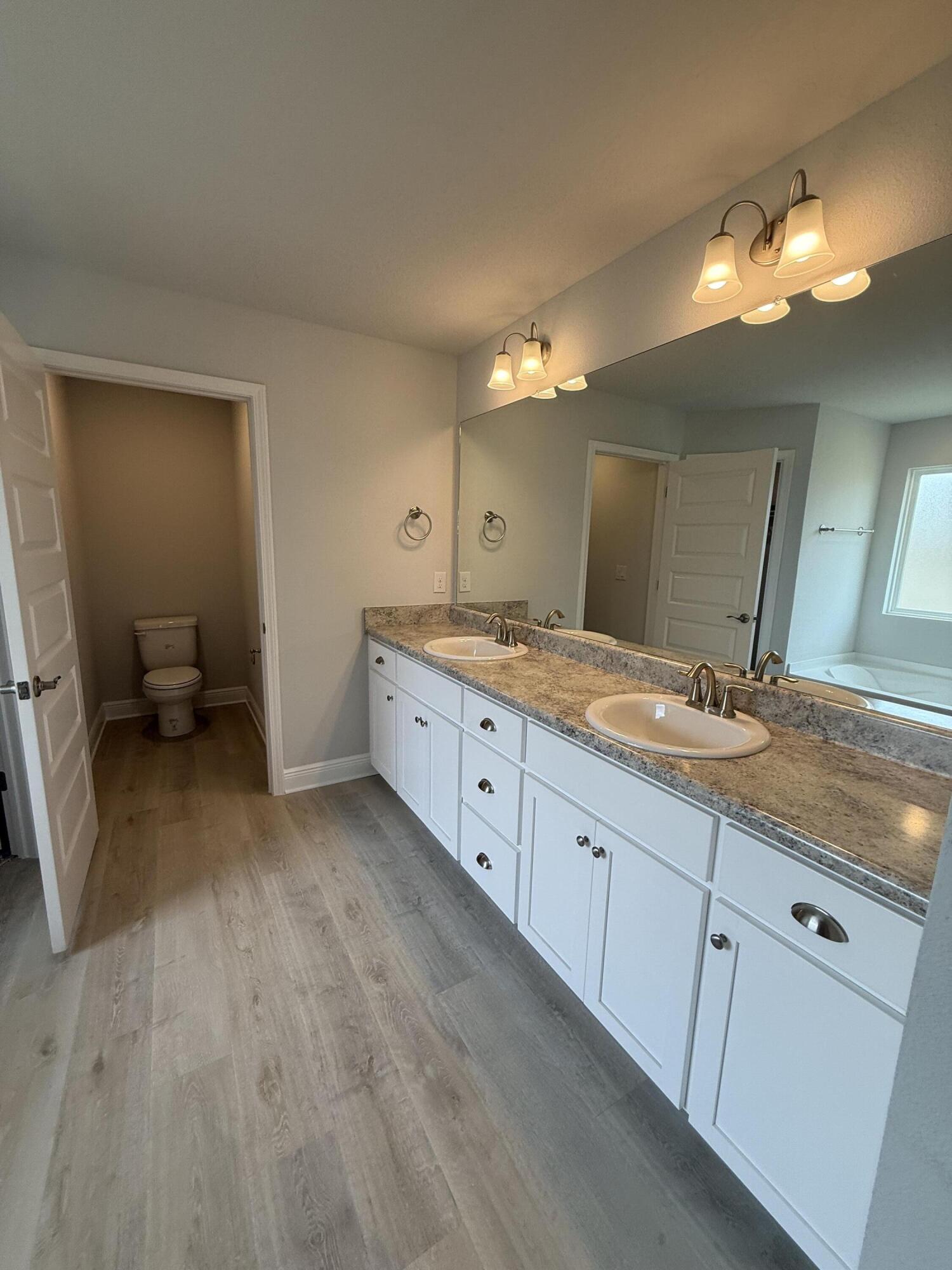 6002 Crocket Cove Crestview, FL 32539 - Photo 23 of 29 a spacious bathroom with a double vanity sink and a mirror