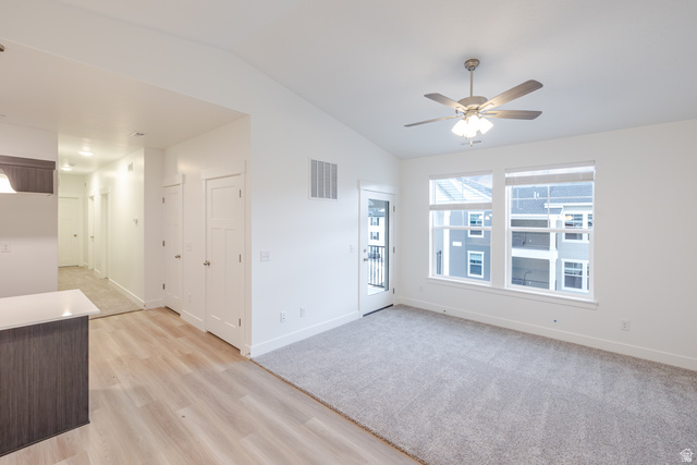 4661 Poplar Way, Unit R303 Mapleton, UT 84664 - Photo 16 of 17 Empty room featuring lofted ceiling, light wood-style floors, and a ceiling fan