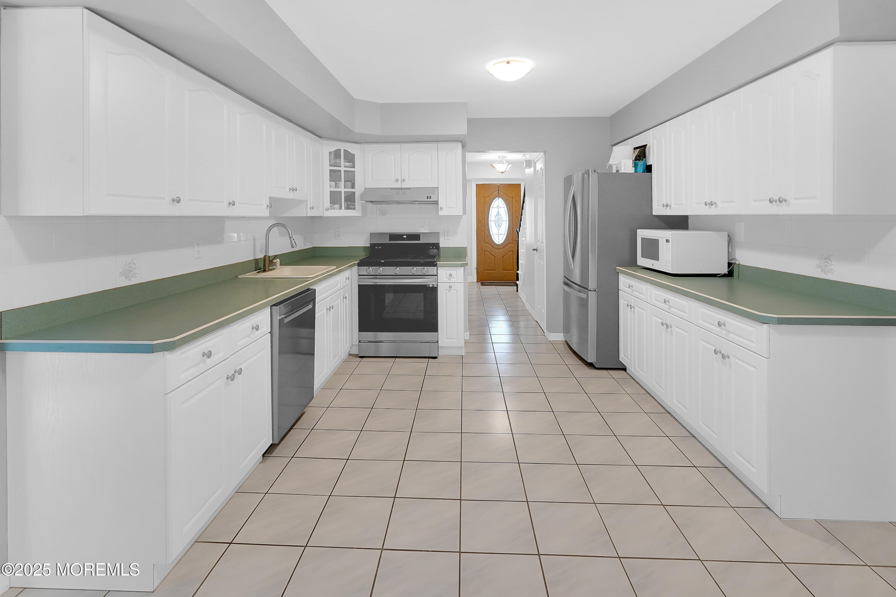 12 Quailtree Lane Howell, NJ 07731 - Photo 26 of 51 a kitchen with stainless steel appliances a sink and cabinets