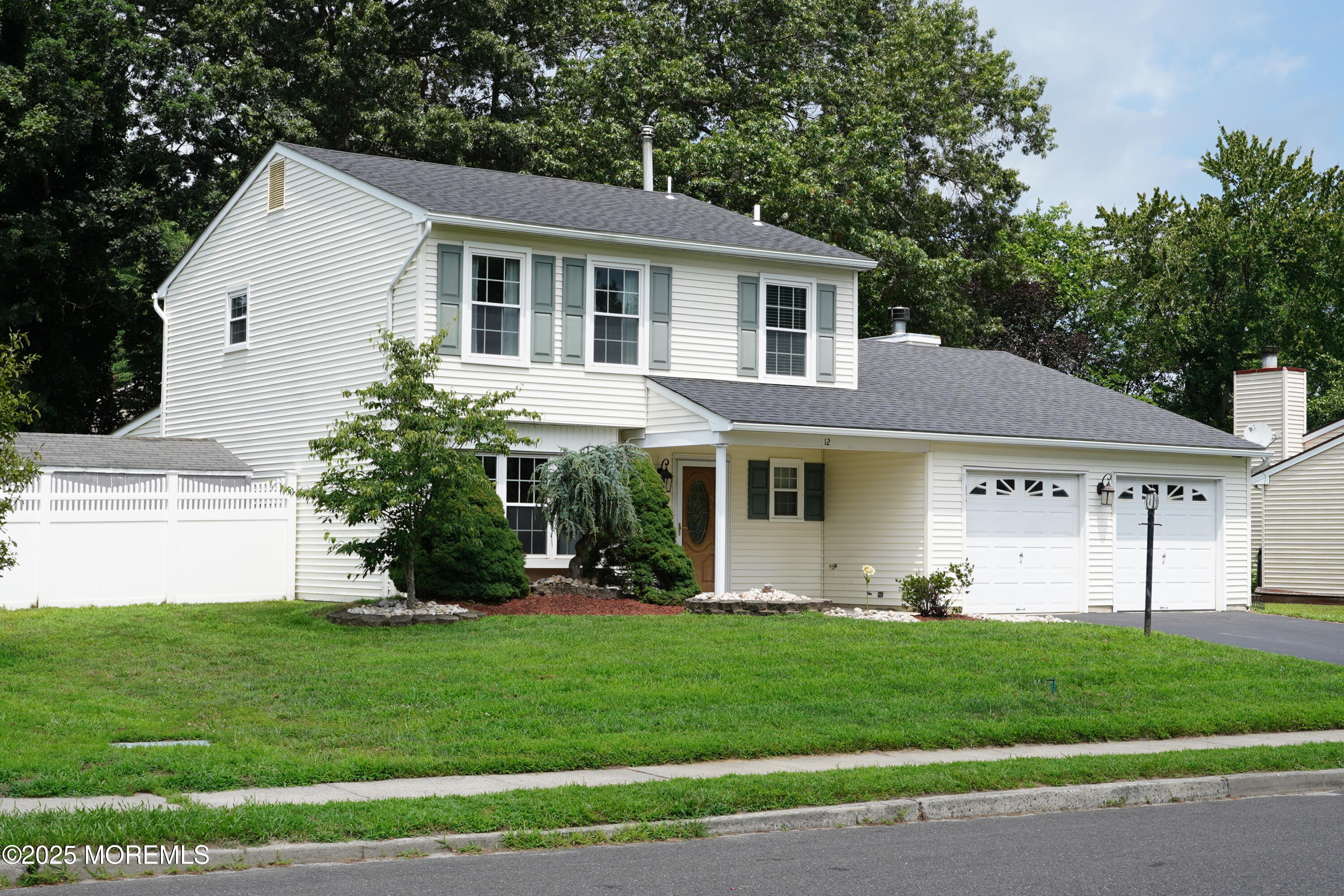 12 Quailtree Lane Howell, NJ 07731 - Photo 3 of 51 a front view of a house with a garden and plants