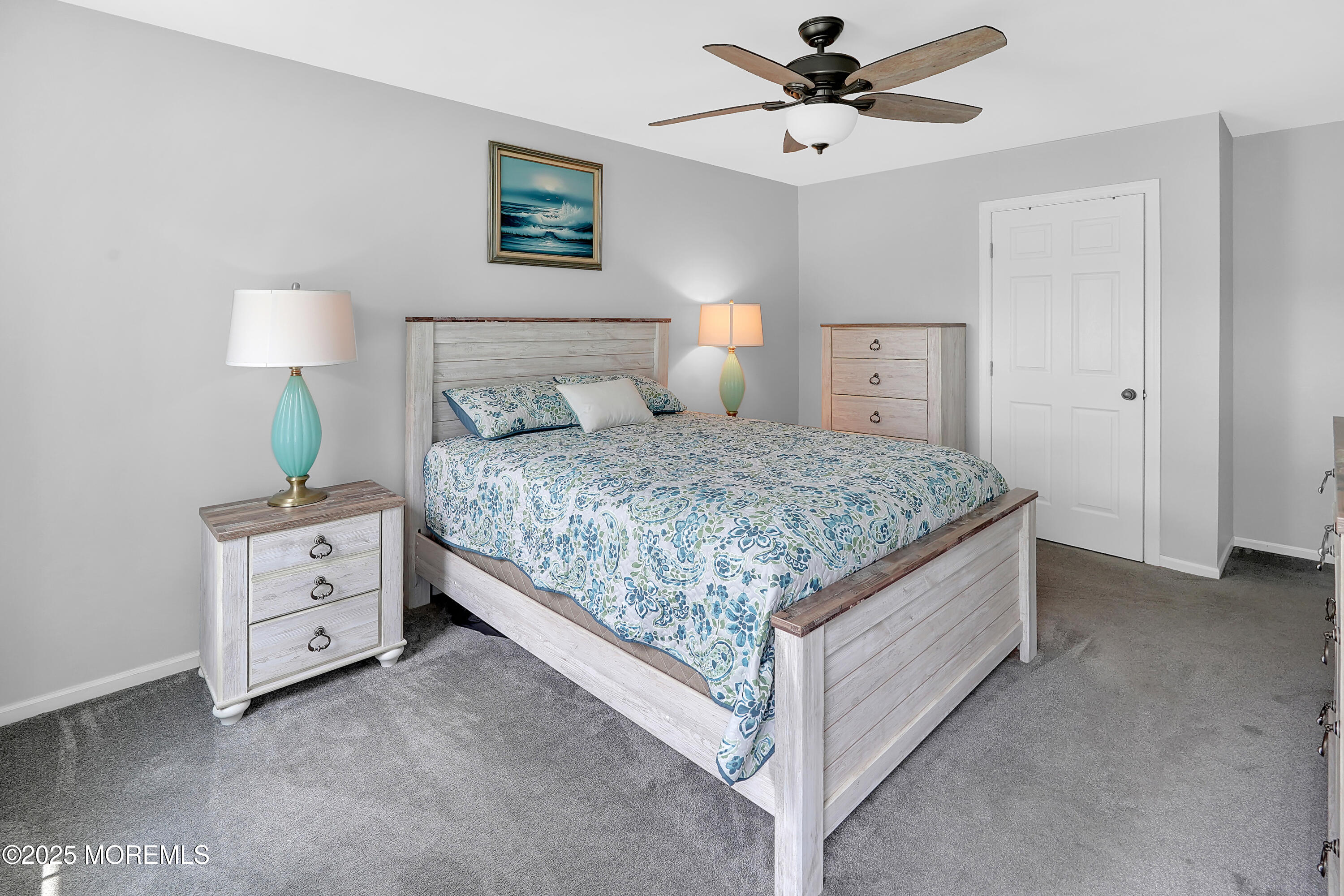 12 Quailtree Lane Howell, NJ 07731 - Photo 33 of 51 a bedroom with a bed and a chandelier